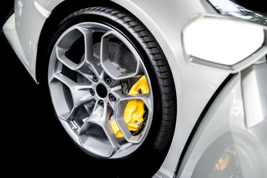Close up of a modern sport wheel with yellow brake