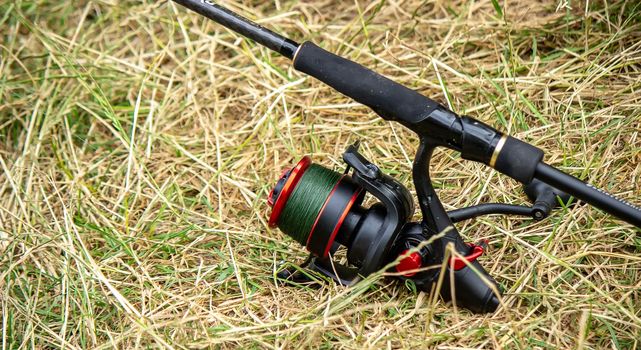 Fishing tackle on the river bank, bait rod, spinning rod, fish. Nature. Selective focus