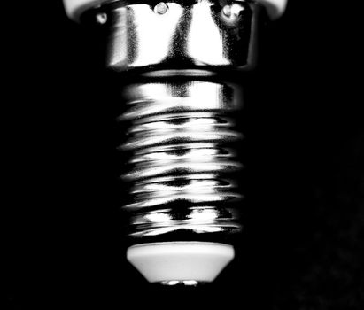 E14 Led bulb base macro photography on black background