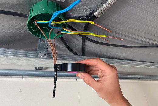 Electrical wiring of the junction box, installation, twisting of the box by an electrician. Selective focus.