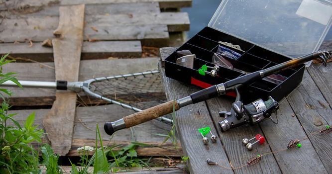 Fishing tackle on the river bank, bait rod, spinning rod, fish. Nature. Selective focus
