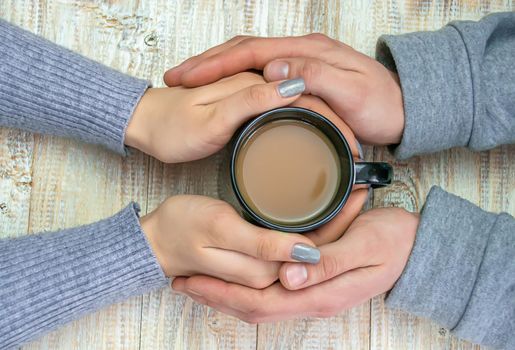 Concept of male and female hands, love and coffee