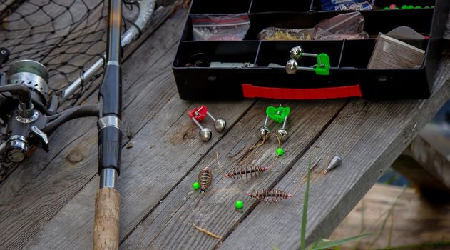 Fishing tackle on the river bank, bait rod, spinning rod, fish. Nature. Selective focus