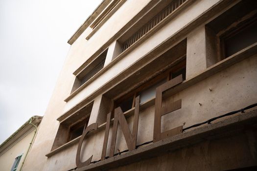 old building of a cinema with the letters put on the facade of concrete