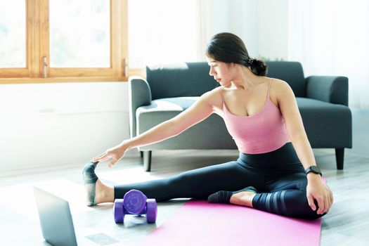 stress relief, muscle relaxation, breathing exercises, exercise, meditation, portrait of Young Asian woman relaxing her body from office work by practicing yoga by watching online tutorials