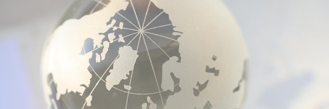 Closeup of glass transparent globe with world map. International financial market concept