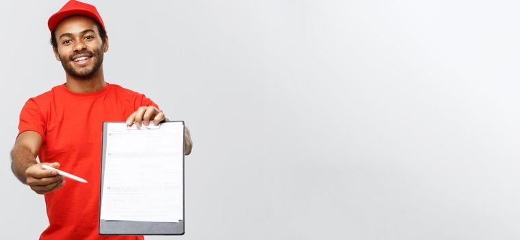 Delivery Concept - Portrait of Handsome African American delivery man or courier showing a confirmation document form to sign. Isolated on Grey studio Background. Copy Space