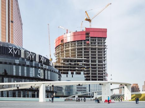 MOSCOW, RUSSIA - October 03, 2020. Moscow International Business Center MIBC . Construction site near Afimall. Building structure of new tower. People walking on square near Cinema-Concert Hall.