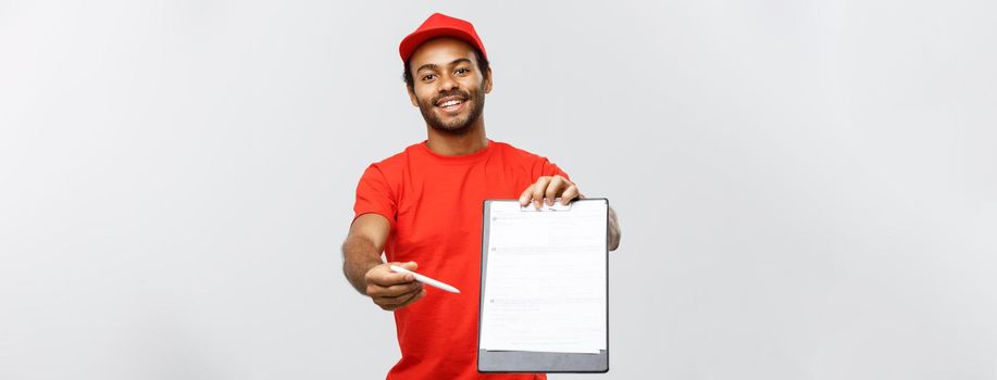 Delivery Concept - Portrait of Handsome African American delivery man or courier showing a confirmation document form to sign. Isolated on Grey studio Background. Copy Space