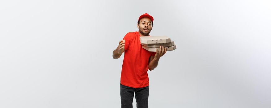 Delivery Concept - Portrait of Handsome African American Pizza delivery man. Isolated on Grey studio Background. Copy Space