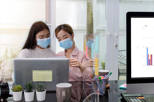 Asian Business Team Meeting Brainstorming Business start up working at Private Home Office social distancing among Coronavirus outbreak New generation business people meeting analysis work from laptop