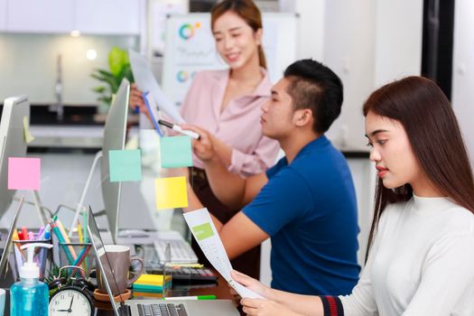 Businesswomen holding document paper chart sitting at Private Home Office with partners background. Asian small business start up  concept.