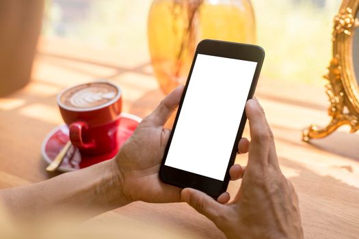 Close up hands of beautiful young woman holding mobile, smart phone sitting in cafe. Soft focus hands of women holding and use cell phone in coffee shop. Tectechnology and lifestyle concept.