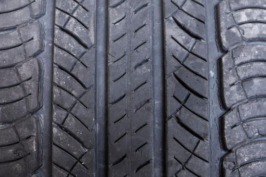 Close up macro old tire background , Non Slip rubber pad made from old tire. Old tire with damage. Automobile tire cover. Texture of rubber on wheels