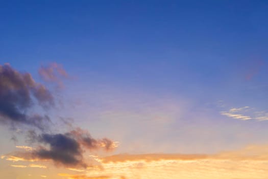 Beautiful morning clear sky background. Colorful yellow blue sky. Morning colorful clear blue sky background with soft white clouds sunrise or sunset.