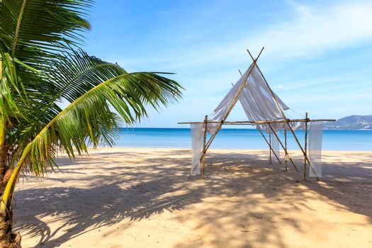 Beautiful tropical beach the calm sea with cloud and sky background. Sun over tropical beach. Nature summer  concept. Bamboo and white cloth theme for camera shot on beach