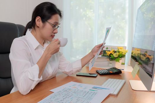 Asian business women working at home online meeting with video conference on computer. Business people using computer online meeting and speaking with team group.