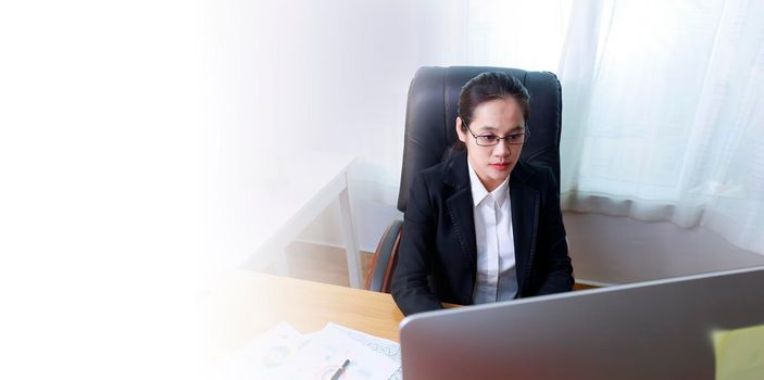 Asian business women analysis paper chart and typing keyboard insert data to computer at office. Business people working at home with internet. Banner