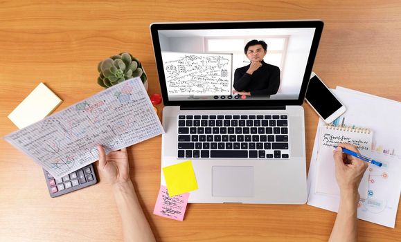 High angle view of video conference with teacher on laptop at home. Top view businesswomen using laptop meeting with colleagues. Covid-19 work from home.,  e-learning education concept.