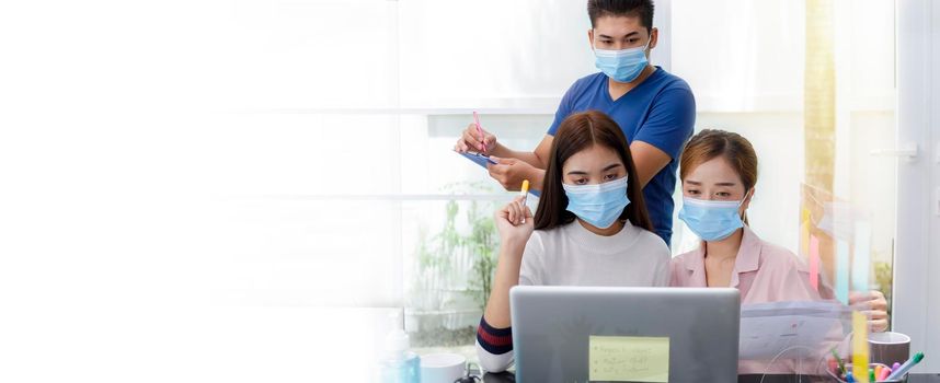 Asian Business Team Meeting Brainstorming Business start up working at Private Home Office social distancing among Coronavirus outbreak New generation business people meeting analysis work from laptop