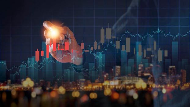 Businessman writing analyze graph for trade stock market on the screen. Businessman hand drawing chart graph stock of growth. Hand man uses pen to draw stock graph chart point of target success.