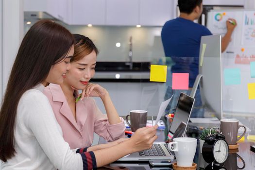 Asian Business Team Meeting Brainstorming Business start up working at Private Home Office social distancing among Coronavirus outbreak New generation business people meeting analysis work from laptop