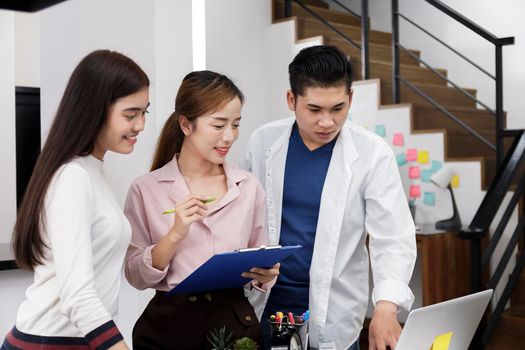 Business Team brainstorm meeting. Group of business people working at Private Home Office.Young business people working with laptop .Asian teamwork business people share idea with team at office