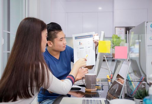 Asian small business startup multiracial working at Private Home Office social distancing among Coronavirus outbreak. Business people show and talking about document chart financial report. 