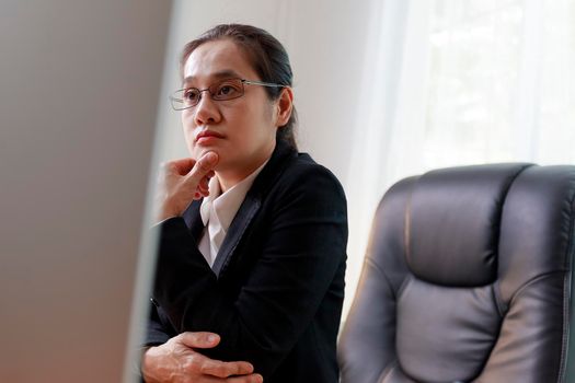 Tired women worker from headache or migraine at workplace. Female employees have problems from work. Young man having sressful time working on computer PC