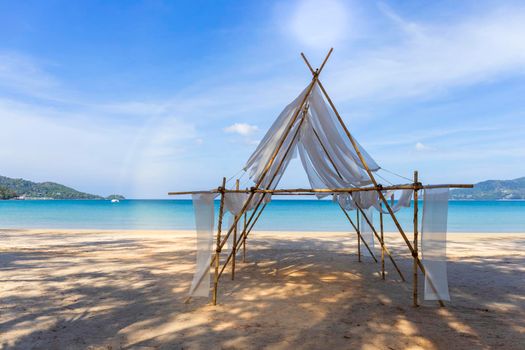 Beautiful tropical beach the calm sea with cloud and sky background. Sun over tropical beach. Nature summer  concept. Bamboo and white cloth theme for camera shot on beach