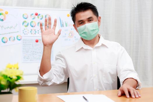 Asian business man using video call contact with friend, customers, partners from home. coronavirus outbreak crisis Business people wear protective face mask work from home with video conference.