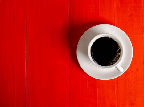 Coffee Mug on Wooden Table. Top view cup of coffee on wooden table. Close up hot coffe in white cup on wood table.