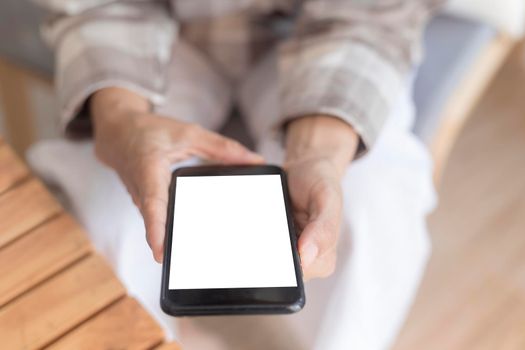 Close up women hands holding smartphone, mobile phone, cell phone with white blank screen for copy space. smart phone with blank screen on women hand soft focus selective phone. Technology lifestyle concept