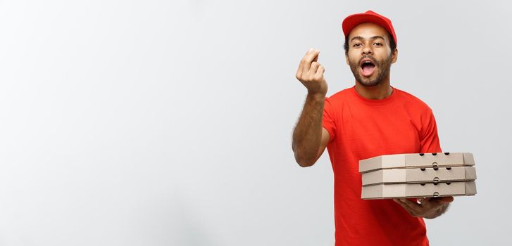 Delivery Concept - Portrait of Happy African American delivery man showing delicious gesture by hand with holding boxes of pizza package. Isolated on Grey studio Background. Copy Space