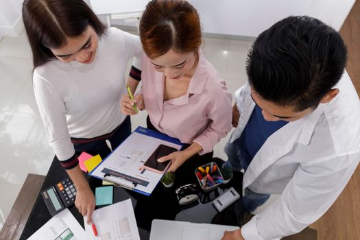 Business Team brainstorm meeting. Group of business people working at Private Home Office.Young business people working with laptop .Asian teamwork business people share idea with team at office