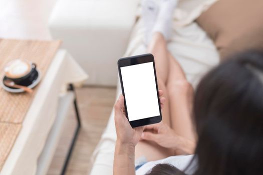 Close up hands of woman using mobile phone, cell phone in coffee shop. Hands of women holding blank empty screen smart phone in cafe. Women relax with mobile phone sit in restaurant
