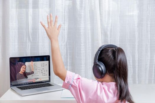 Asian little girl student learning via internet online class from school teacher duling covid-19 outbreak. Man teaching math by whiteboard. Homeschool learn from home concept