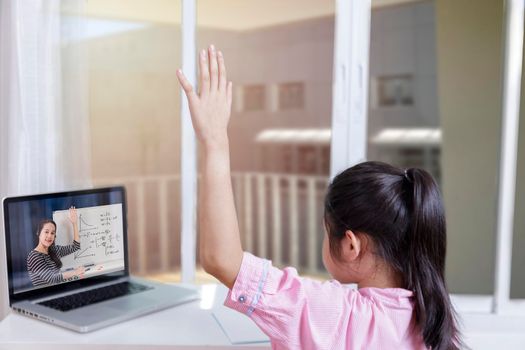 Asian little girl student learning via internet online class from school teacher duling covid-19 outbreak. Man teaching math by whiteboard. Homeschool learn from home concept