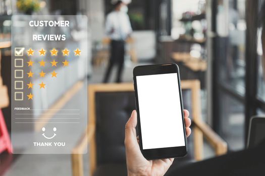 Customer service and Satisfaction concept ,Women hand hold smart phone empty screen choose the 5 star icon to give satisfaction in service. rating very impressed in coffeeshop.