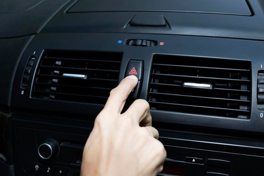 Close up hand press the emergency light in the car, Fingers press button.for open the contract emergency light in car. Emergency button press for open emergency light warning sign symbol out side car