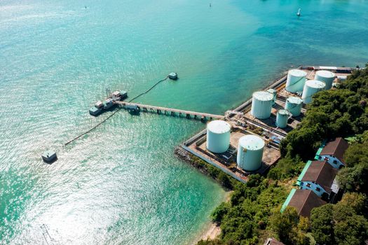 Aerial drone top view of containers cargo ship at industrial import-export port. Business logistic import and export freight transportation by container ship in open sea