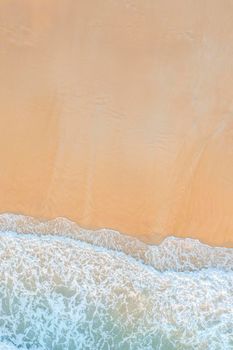 Aerial drone top down view of Abstract of beautiful soft wave come to beach background. Soft wave of blue sea on sand beach background.