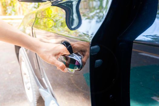 Hand on handle Close up of women hand opening car door