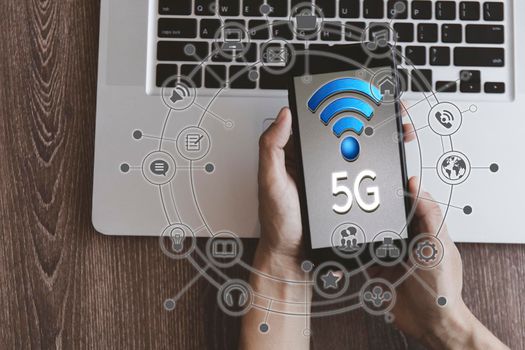 Top view hand of women hold mobilephone connect network 5G with icon concept, technology network wireless systems and internet of things, new technologies coming up in the future. Network connection 5G