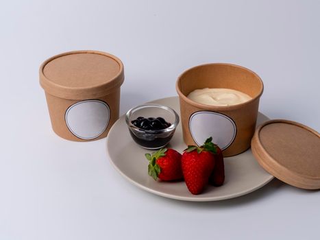 Blueberry cream chesse in craft cup with strawberry on white background
