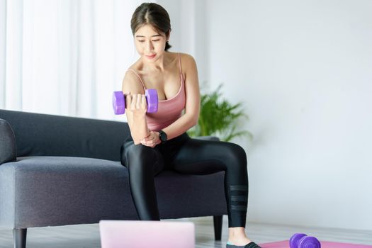 stress relief, , breathing exercises, meditation, portrait of Asian healthy woman lifting weights to strengthen her muscles after work