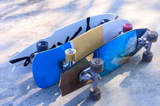 Close up surf skate board at park. Lot of surfskate board on public park