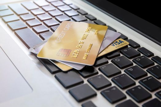 Close up Credit card on laptop of business workplan. many credit card on laptop keyboard of online shopping payment. Credit card payment for purchases from online stores and online shopping,