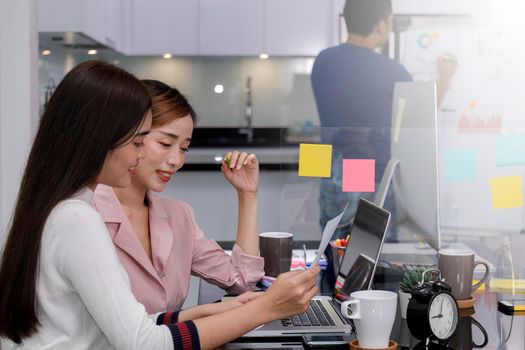 Asian Business Team Meeting Brainstorming Business start up working at Private Home Office social distancing among Coronavirus outbreak New generation business people meeting analysis work from laptop