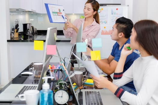 Asian small business start up working at Private Home Office social distancing covid-19 outbreak . Business people show and talking about document chart financial report. Start up teamwork brainstorm